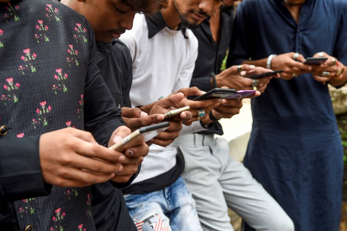 Young eople watch videos on the app TikTok on their mobile phones in Mumbai, India, in November 2019.