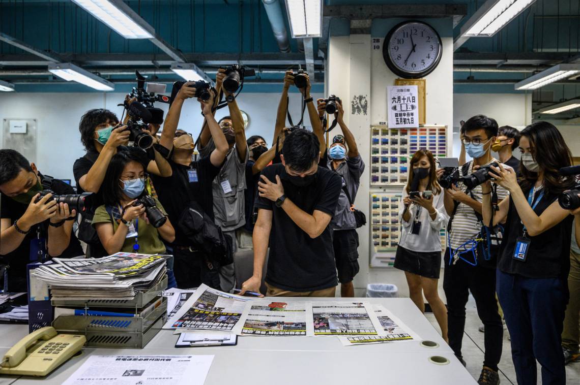 Executive editor in chief Lam Man-Chung proof reads the next day’s “Apple Daily&quot; newspaper in Hong Kong on June 17, 2021, after police  arrested the chief editor that morning.