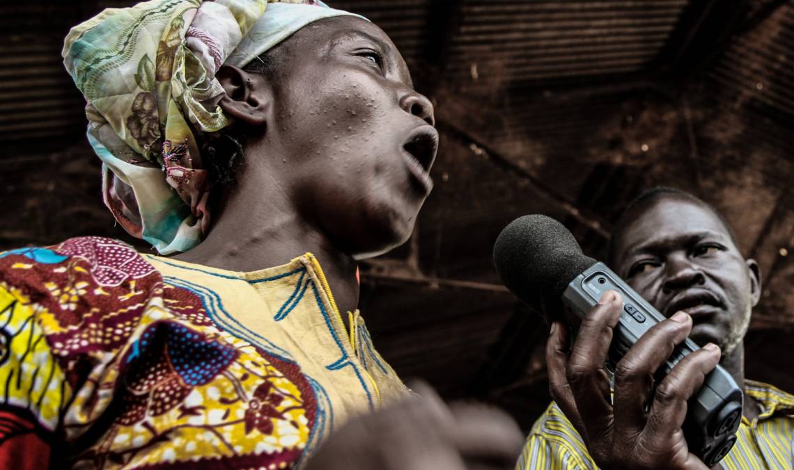 A woman interviewed by a Radio Ndeke Luka reporter at a market in Bangui, Central African Republic.