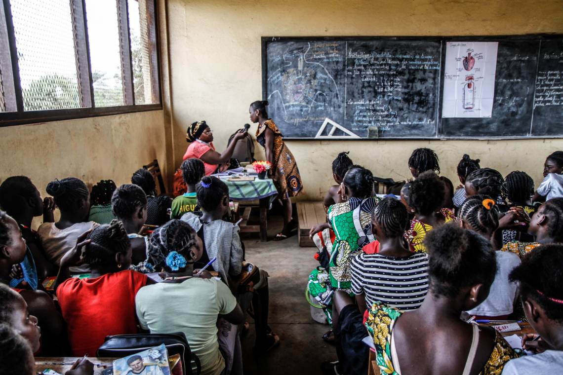 A Radio Ndeke Luka journalist reporting from a classroom in Bangui, Central African Republic.
