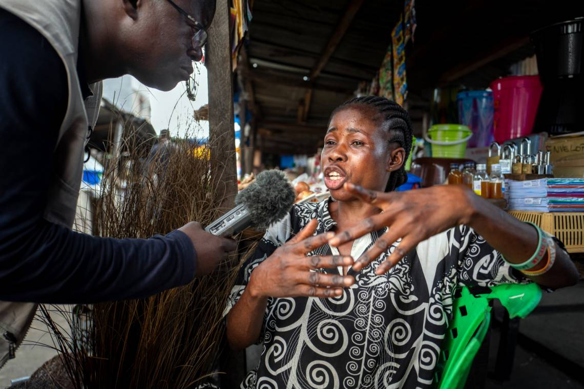 A journalist from Studio Hirondelle RDC reporting in Kinshasa, Democratic Republic of Congo.