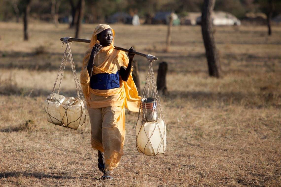A woman is carrying water in the refugees camp of Jamam, in the Upper Nile State of South-Sudan, on December 14th, 2012.