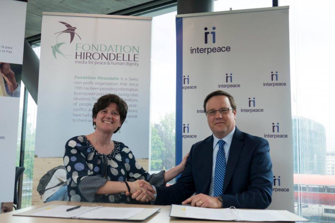 Caroline Vuillemin, Fondation Hirondelle&#039;s CEO, and Scott Weber, Interpeace&#039;s CEO, during the signing ceremony in Geneva, on May 4th, 2017.