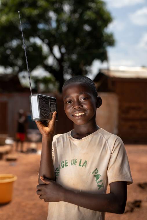 A young boy listens to Radio Ndeke Luka, the main radio station in the Central African Republic, in Bangui, the capital of the Central African Republic.