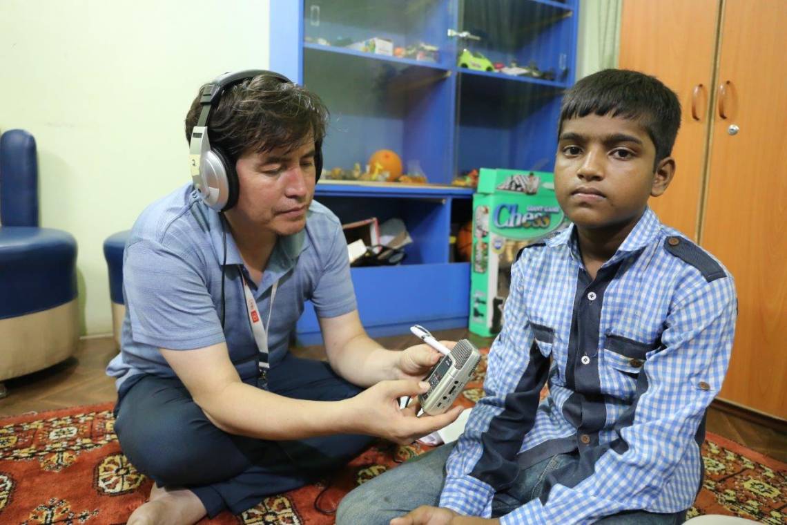 An Afghan participant to the workshop interviewing a child for an audio documentary, on July 18, 2017 in Karachi.