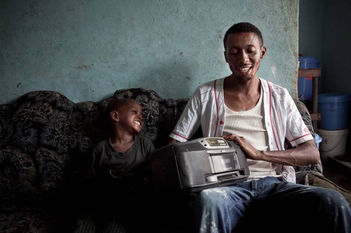 Un père et son fils écoutent la radio à Kinshasa, RDC.