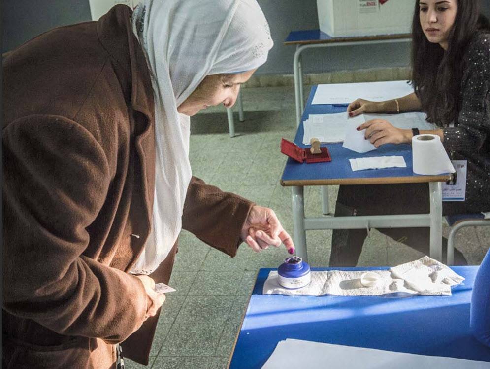 A woman votes in the 2014 presidential elections in Tunisia.
