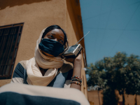 A woman listening to radio in Niamey, Niger, in April 2020. 